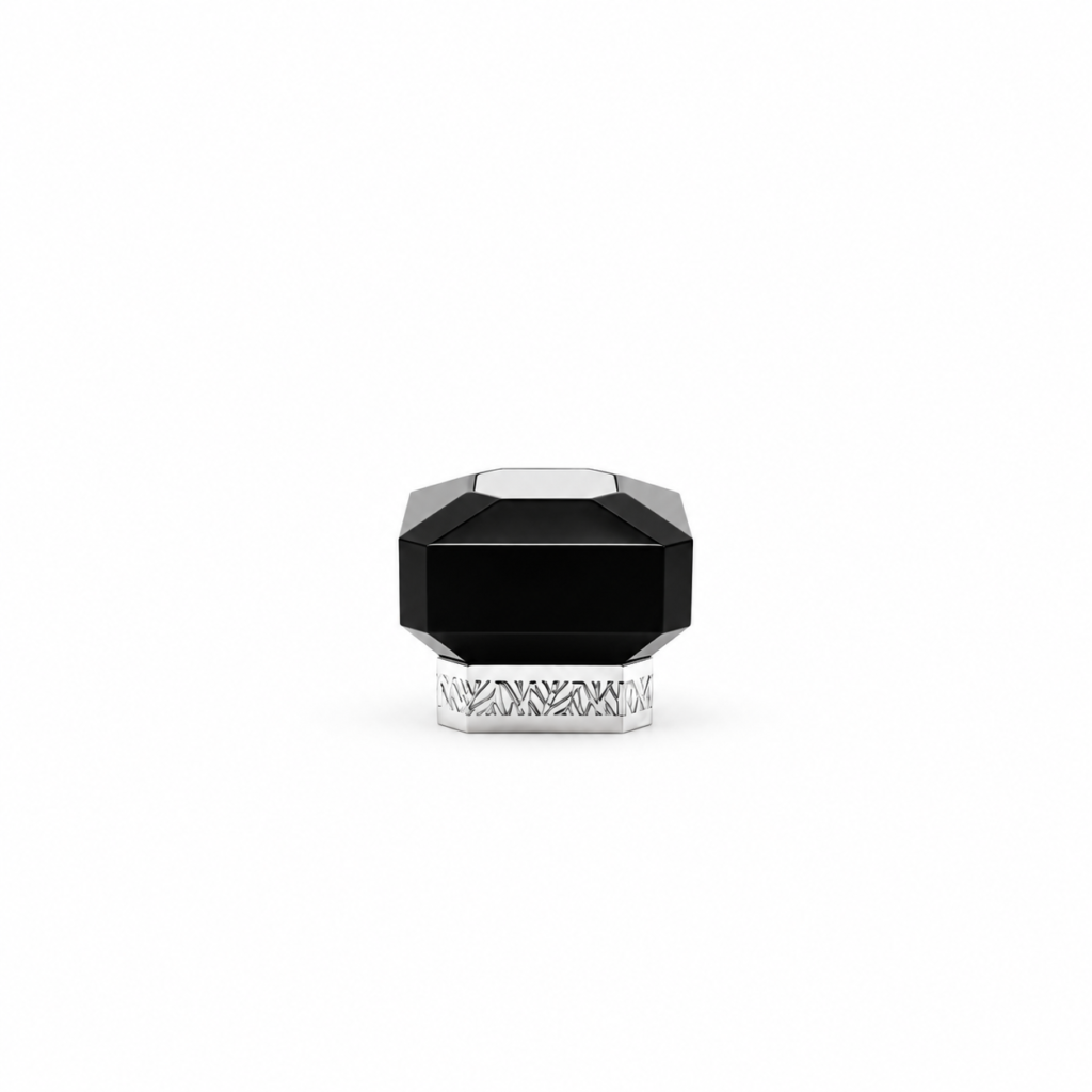 Black faceted perfume bottle cap with a silver top accent and patterned silver base, shown from the front.