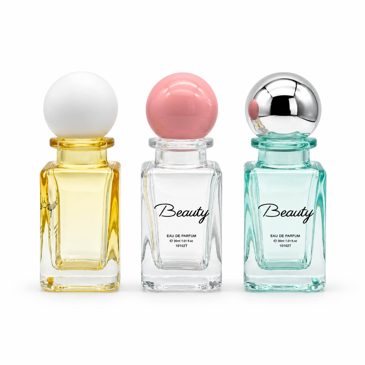 Three 30ml rectangular glass perfume bottles in yellow, clear and aqua tones with white, pink and silver-tone spherical caps