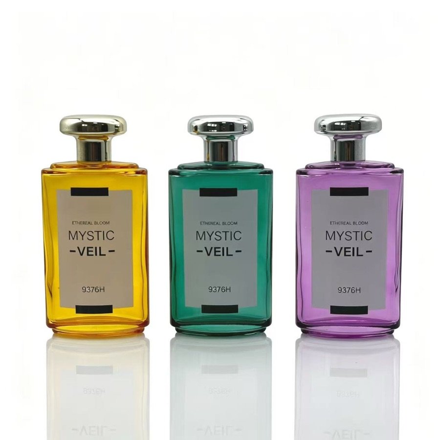 Three glass perfume bottles with different coloured finishes and matching caps